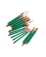 Pile of green makeup brushes